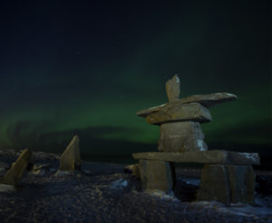 Northern lights and rock sculpture